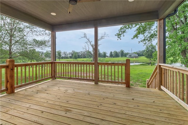 wooden deck featuring a lawn