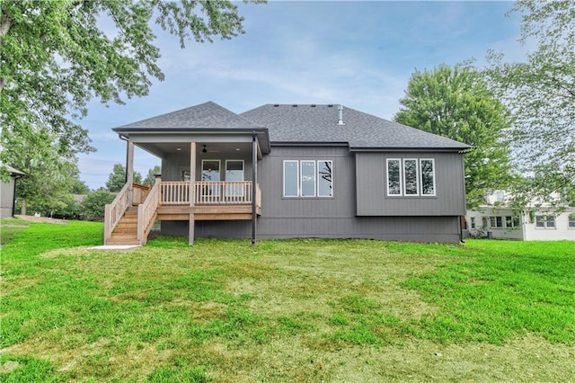 rear view of property featuring a lawn