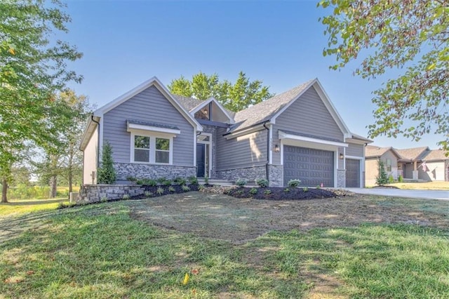 craftsman house featuring a front yard and a garage