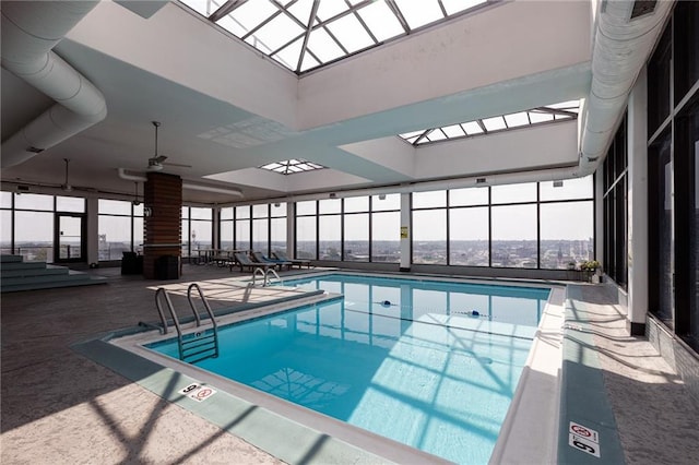 view of swimming pool with a skylight and ceiling fan