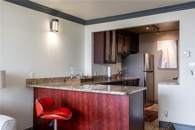 700 E 8th St Unit 11P, Kansas City, MO 64106 - kitchen with freestanding refrigerator, a peninsula, ornamental molding, track lighting, and a sink