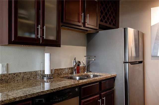 700 E 8th St Unit 11P, Kansas City, MO 64106 - kitchen featuring appliances with stainless steel finishes, a sink, light stone countertops, glass insert cabinets, and reddish brown cabinets