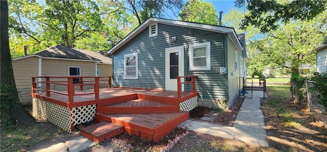 back of property featuring fence and a deck