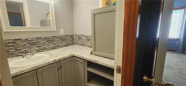 bathroom with vanity and decorative backsplash