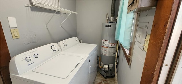 clothes washing area with water heater, laundry area, and washer and dryer