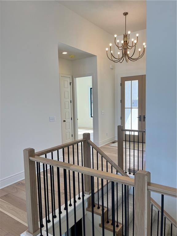 stairway featuring baseboards and wood finished floors