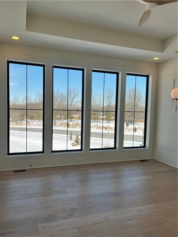 spare room featuring recessed lighting, visible vents, plenty of natural light, and wood finished floors