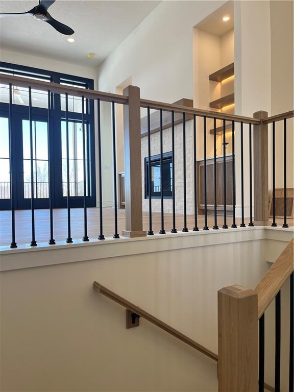 stairs with recessed lighting and a ceiling fan