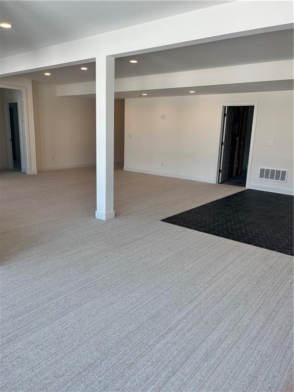 finished basement with recessed lighting, visible vents, baseboards, and light colored carpet