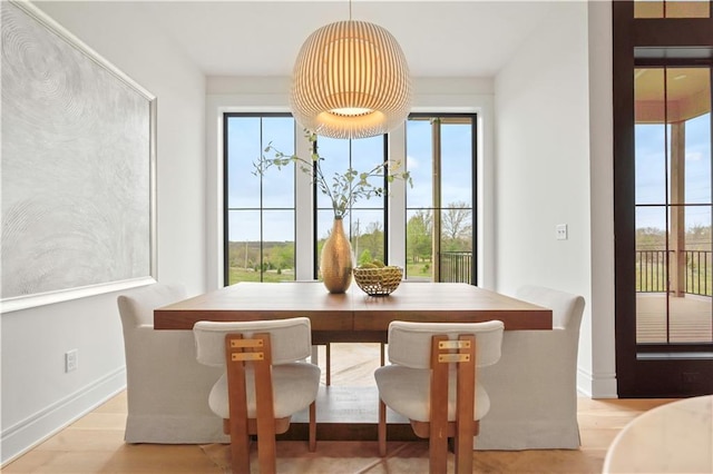 1816 NE Lashbrook Cir, Lees Summit, MO 64086 - dining area featuring baseboards and light wood-style flooring