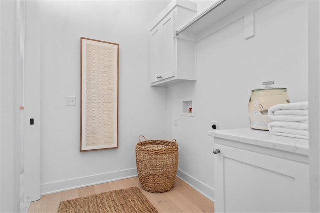 1816 NE Lashbrook Cir, Lees Summit, MO 64086 - clothes washing area with hookup for a washing machine, electric dryer hookup, cabinet space, light wood finished floors, and baseboards