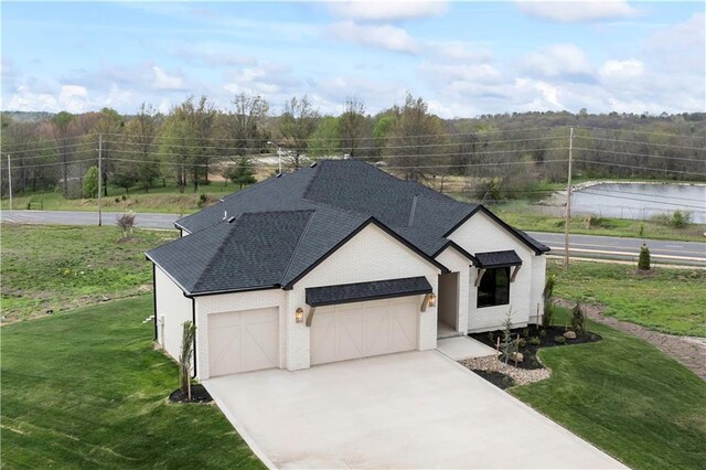 1816 NE Lashbrook Cir, Lees Summit, MO 64086 - view of front facade with brick siding, concrete driveway, an attached garage, a front yard, and roof with shingles