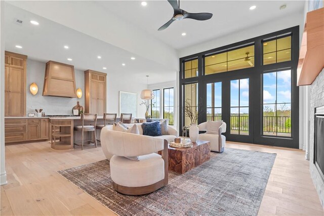 1816 NE Lashbrook Cir, Lees Summit, MO 64086 - living room featuring a ceiling fan, a glass covered fireplace, light wood-style floors, and recessed lighting