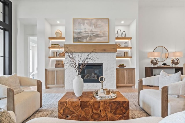 1816 NE Lashbrook Cir, Lees Summit, MO 64086 - living area featuring built in features, a brick fireplace, wood finished floors, and recessed lighting