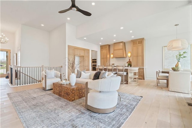1816 NE Lashbrook Cir, Lees Summit, MO 64086 - living area featuring light wood-type flooring, recessed lighting, and ceiling fan with notable chandelier