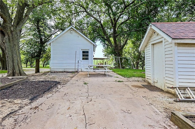 view of patio / terrace featuring a storage unit