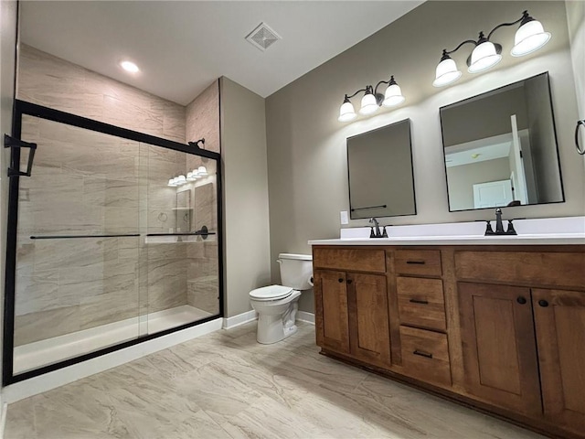 bathroom featuring vanity, toilet, and an enclosed shower