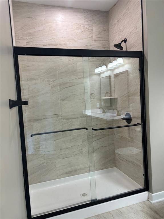 bathroom with a shower with shower door