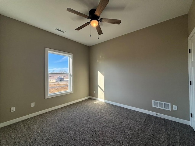 carpeted spare room featuring ceiling fan