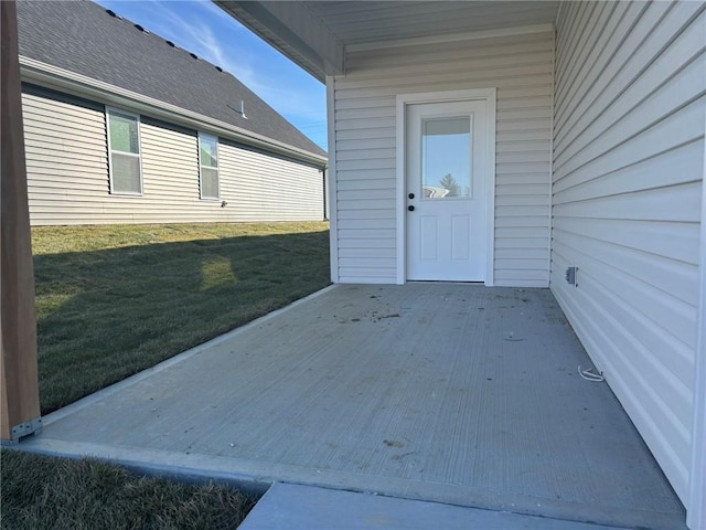 view of exterior entry featuring a yard