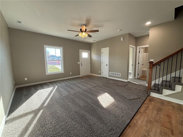 carpeted entrance foyer with ceiling fan