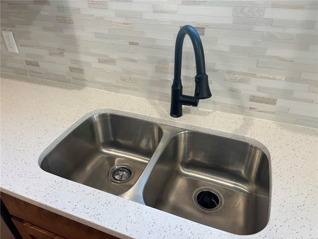 room details with light stone counters and sink