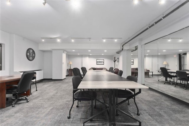 dining space featuring rail lighting and carpet flooring