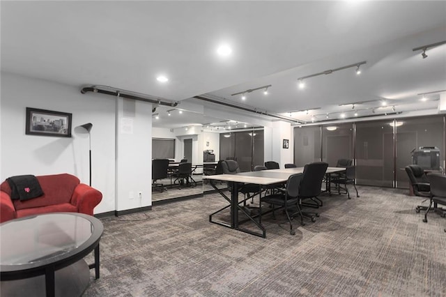 dining area with dark colored carpet and track lighting