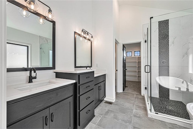 bathroom with vanity, plus walk in shower, and tile patterned flooring