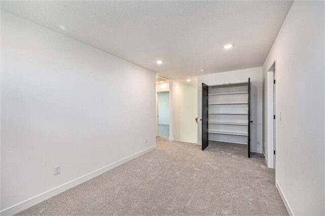 unfurnished bedroom featuring light colored carpet