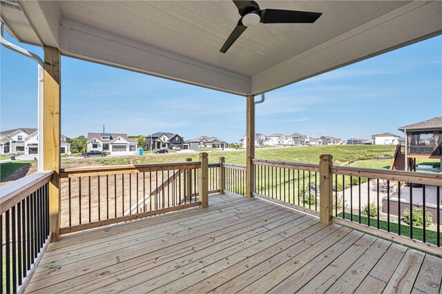 deck featuring a yard and ceiling fan