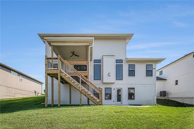 back of house with a yard, ceiling fan, and central AC