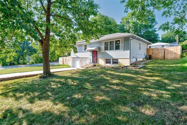 raised ranch with a garage and a front yard