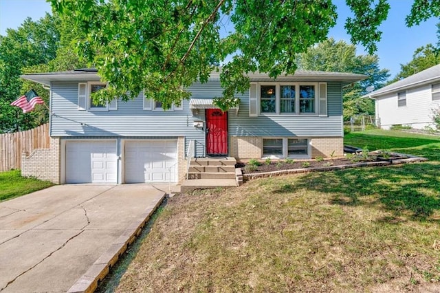 raised ranch with a garage and a front yard