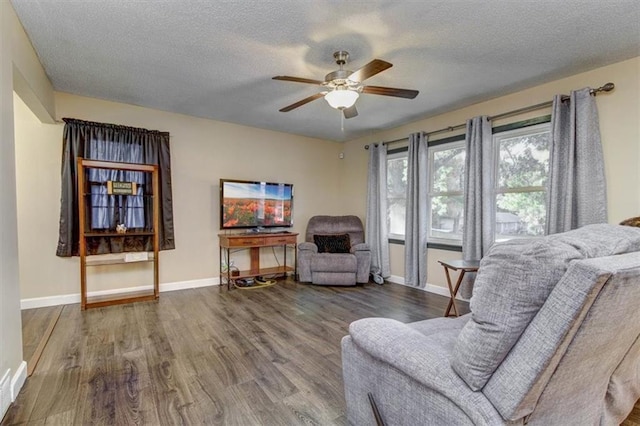 sitting room featuring ceiling fan, hardwood / wood-style flooring, and a textured ceiling