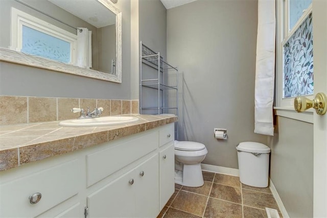 bathroom featuring vanity, toilet, and tile patterned flooring