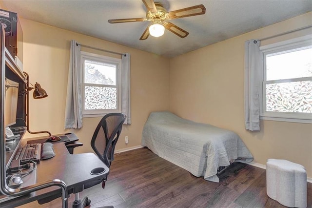 bedroom with dark wood-type flooring and ceiling fan