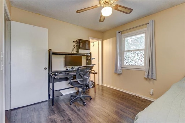 office with dark wood-type flooring and ceiling fan