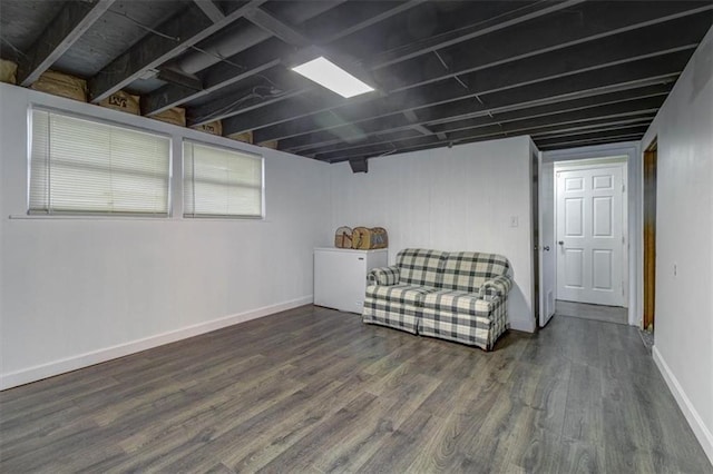 basement with dark hardwood / wood-style flooring