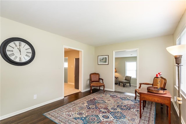 sitting room with dark wood-type flooring