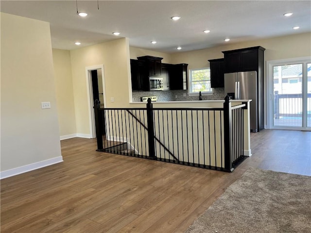 kitchen with sink, decorative backsplash, dark hardwood / wood-style floors, and appliances with stainless steel finishes