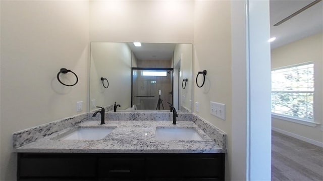 bathroom featuring vanity and an enclosed shower