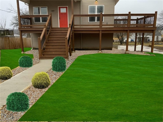 exterior space with stairs, a yard, a deck, and fence