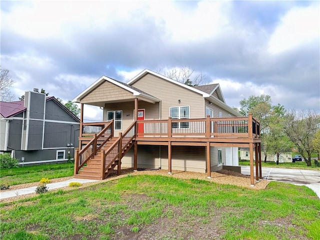 107 S Jefferson Ave, Knob Noster, MO 65336 - view of front facade with stairs, a front yard, and a wooden deck