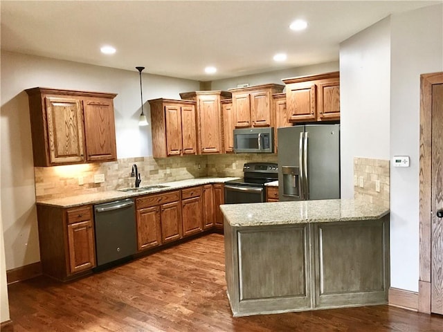 kitchen featuring light stone counters, stainless steel appliances, sink, and dark hardwood / wood-style floors