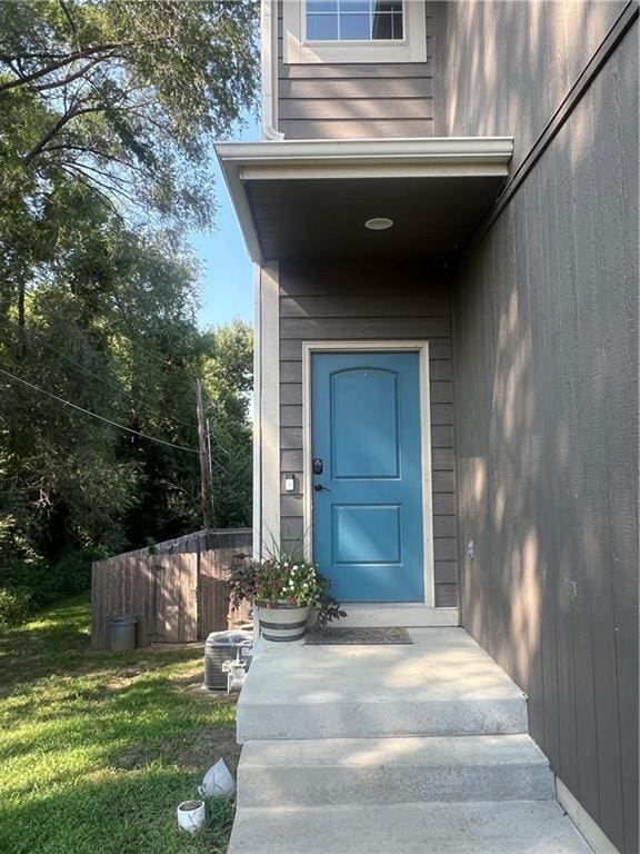 entrance to property with a lawn