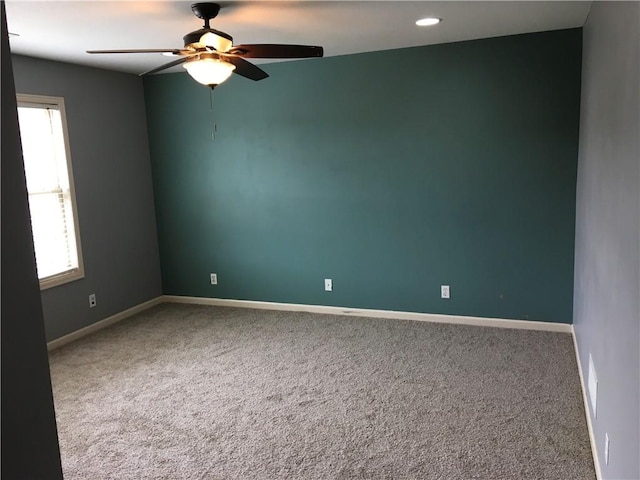 empty room with carpet flooring and ceiling fan