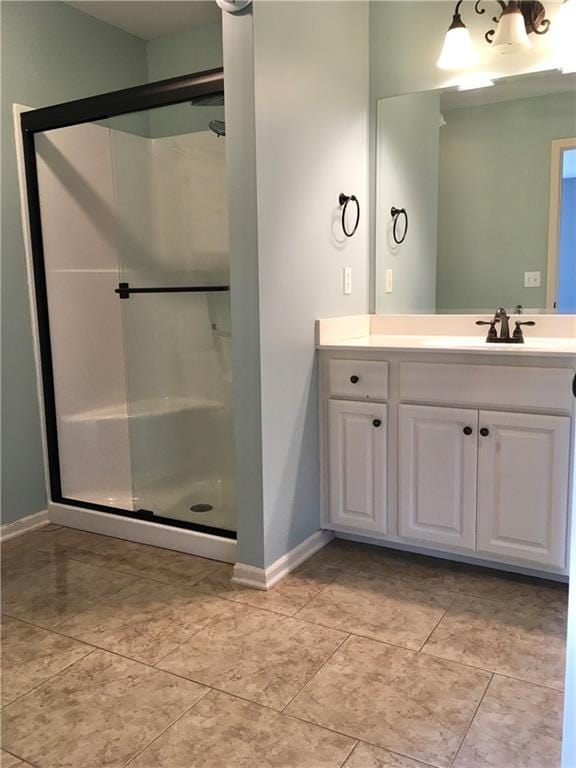 bathroom with vanity and a shower with shower door