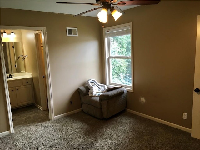 sitting room with ceiling fan, sink, and carpet floors