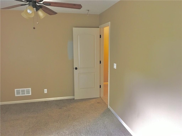 carpeted spare room with ceiling fan